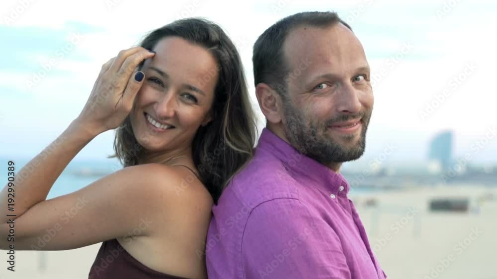 Portrait of happy, young couple sitting near beach in city
Portrait of happy, young couple sitting near beach in city