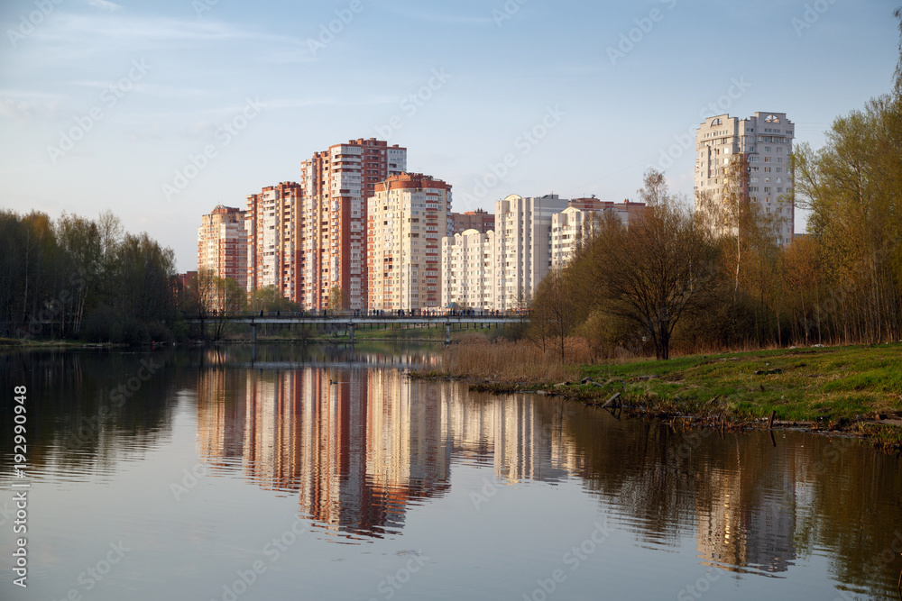 The view from city Park on a pedestrian bridge and a new neighborhood on the banks of the Pekhorka river. Balashikha, Moscow region, Russia.