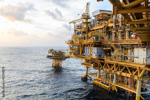 Offshore oil and Gas central processing platform and remote platform produced oil, natural gas and liquid condensate for set to onshore refinery from offshore in ocean sea background.