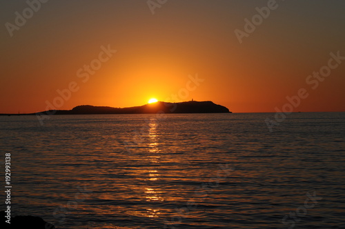 Sunset over the island Illa sa Conillera in Ibiza Spain
