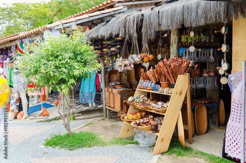 handmade wooden pieces being sold at craft fair in Bahia in Brazil. Spoons, bundles, purses, musical instruments.