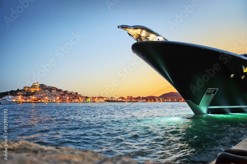 Photography Evening view of Ibiza Town with a superyacht bow