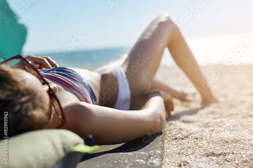 beautiful woman sunbathing on the beach. woman enjoys summer vacation