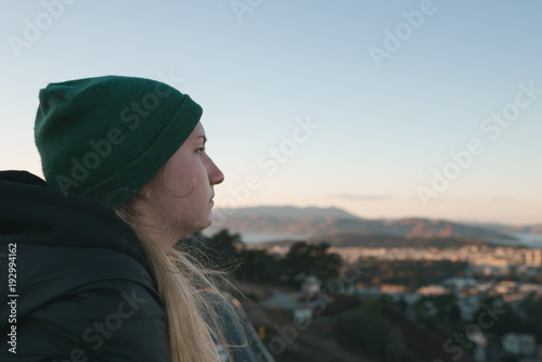 portrait of teen girl looking on San Francisco from Twin Peaks at sunset © GCapture