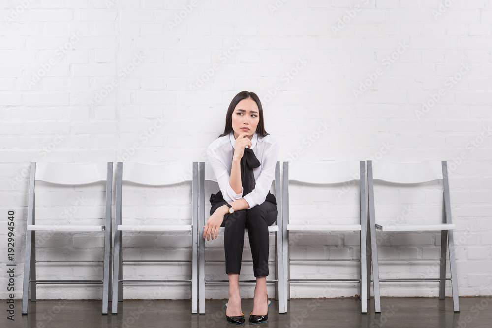Fototapeta premium thoughtful asian businesswoman waiting for job interview
