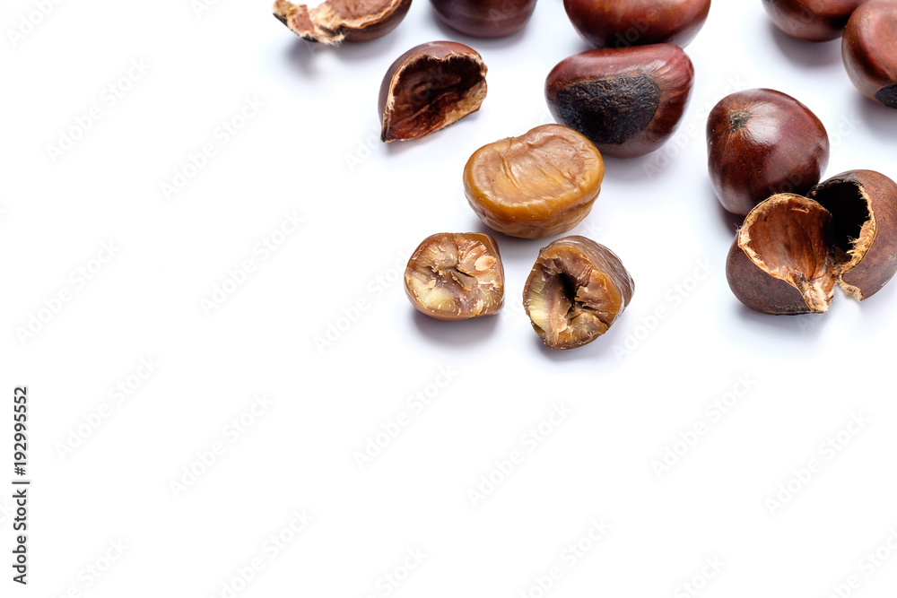 Roasted chestnuts on a white background. Roasted chestnuts on a white background.