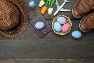 Table top view shot of decoration Happy Easter holiday background concept.Flat lay essential objects plan to travel vacation on modern brown wooden at office desk. Accessory for traveler to trip.