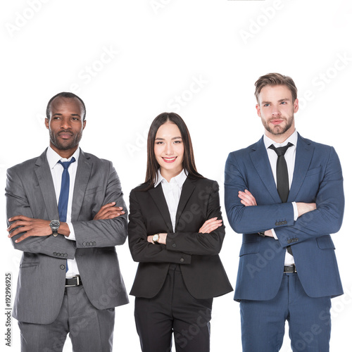 portrait of smiling multicultural young business people with arms crossed isolated on white