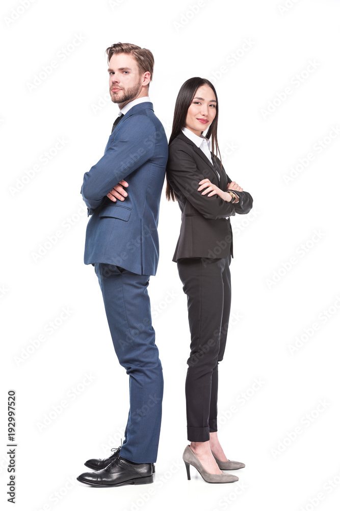 side view of multicultural business colleagues with arms crossed standing back to back isolated on white side view of multicultural business colleagues with arms crossed standing back to back isolated on white
