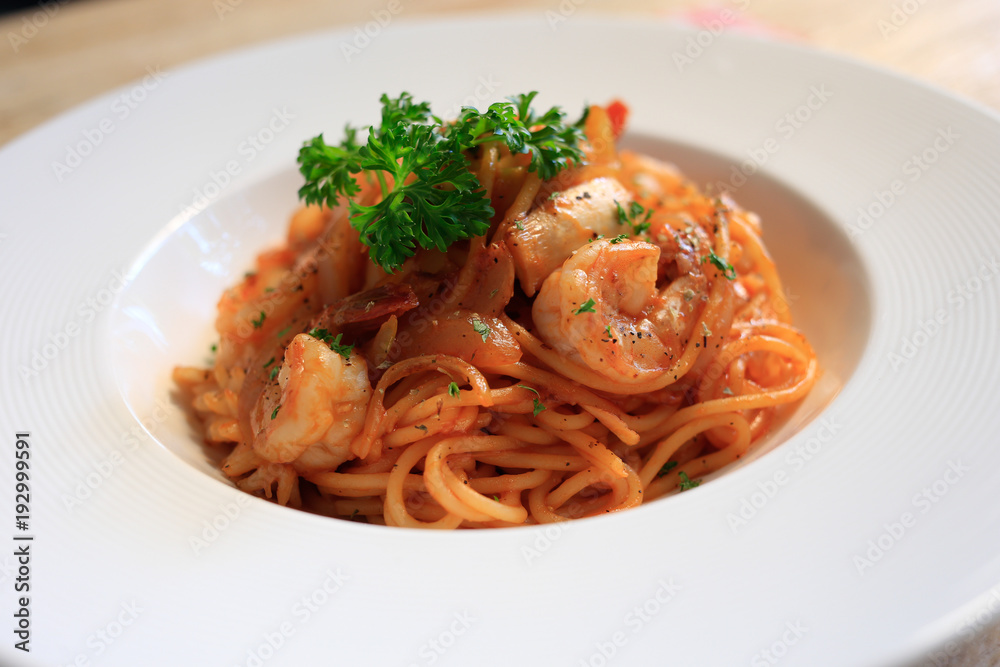 Top view SpaghettiMarinara  on wooden background.