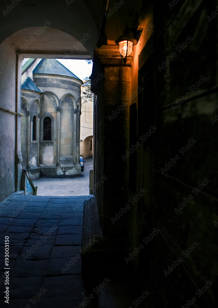 Fototapeta premium Small Church in Yard out off Dark Porch Lantern on Wall