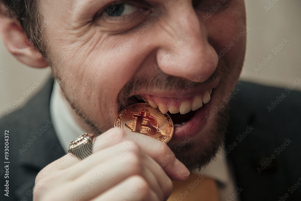man is trying to break the bitcoin with his teeth man is trying to break the bitcoin with his teeth