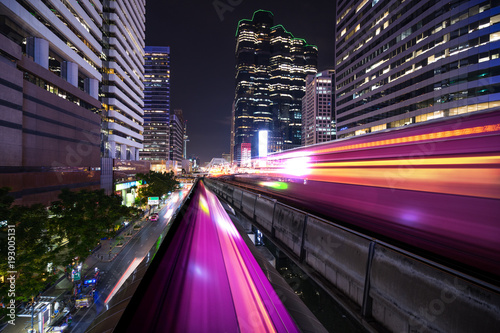 Photography abstract light tail of sky train in urban cityscape at night