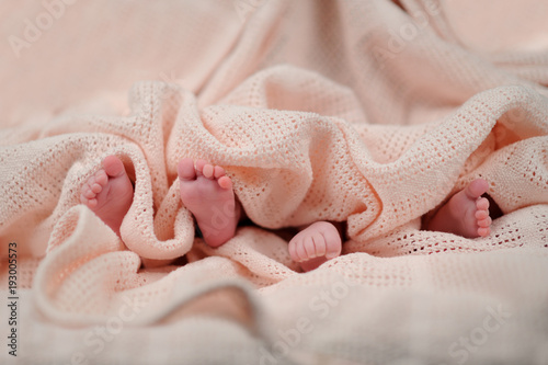 mother holding premature twins legs