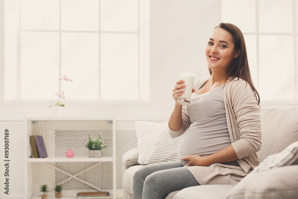 Pregnant woman drinking glass of milk copy space Pregnant woman drinking glass of milk copy space