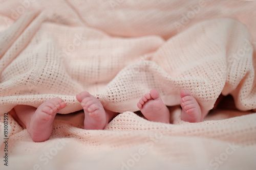 mother holding premature twins legs