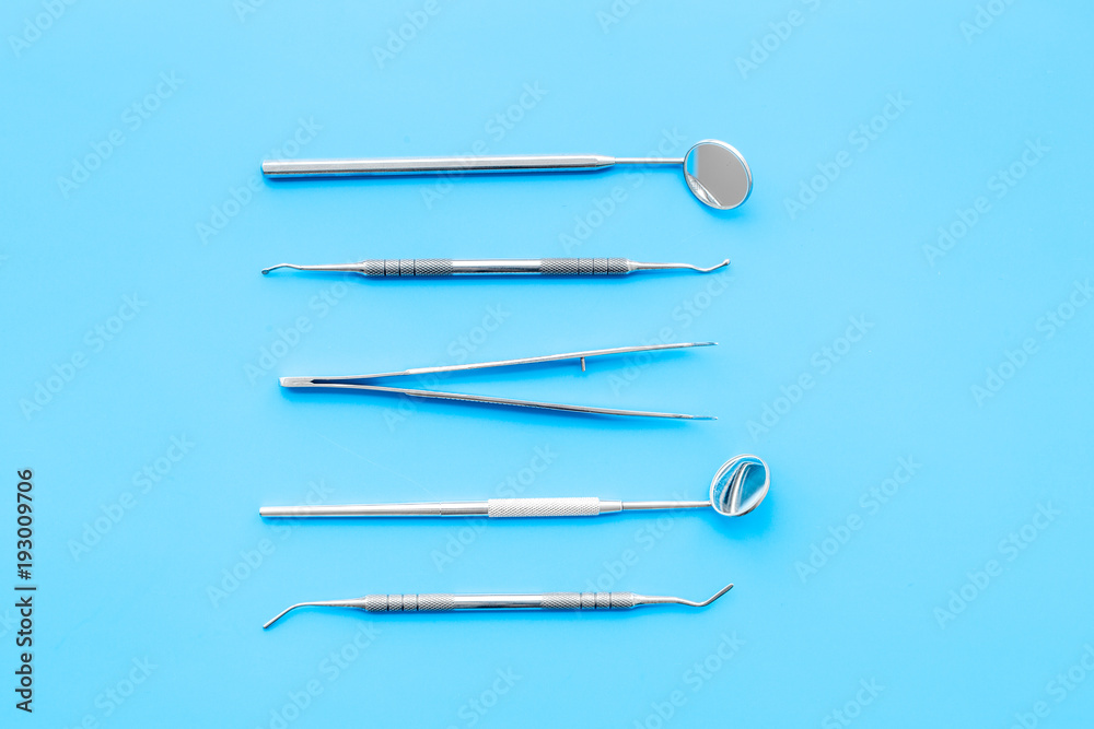Dentist tools. Prevention of diseases of the oral cavity. Dentist appointment. Blue background top view Dentist tools. Prevention of diseases of the oral cavity. Dentist appointment. Blue background top view