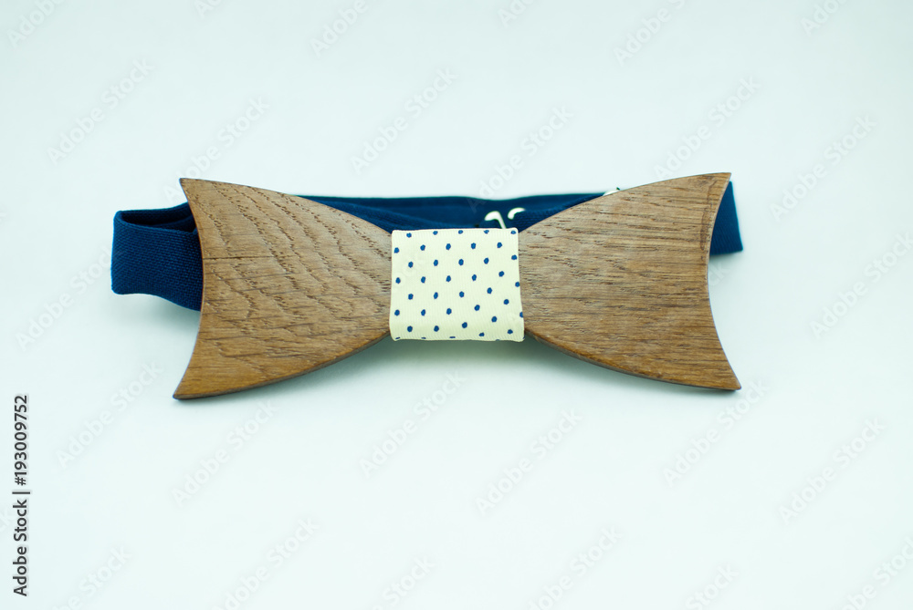 Stylish wooden bowtie with blue-yellow soft cloth ribbon. Isolated