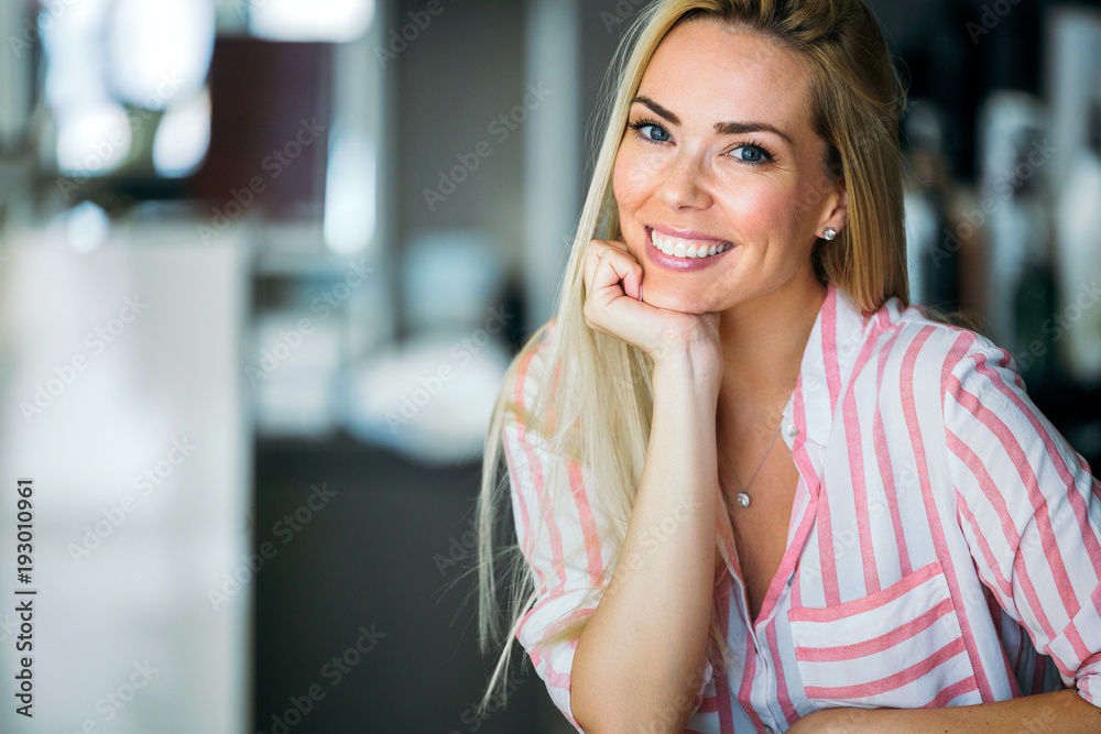 Obraz premium Portrait of beautiful young happy smiling woman with long hair