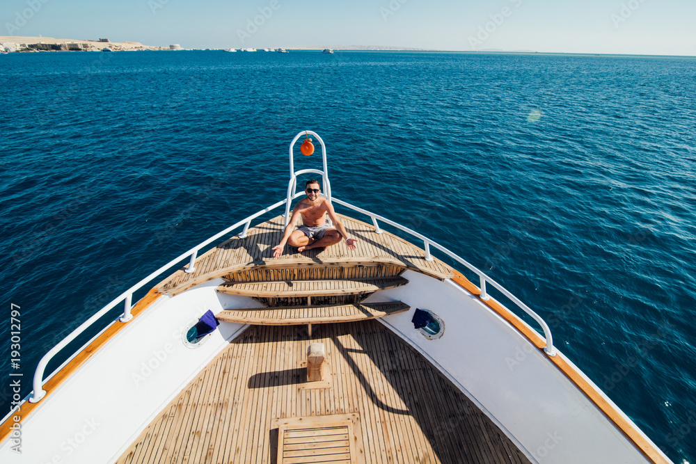Fotografie Handsome man on a yacht in the summer