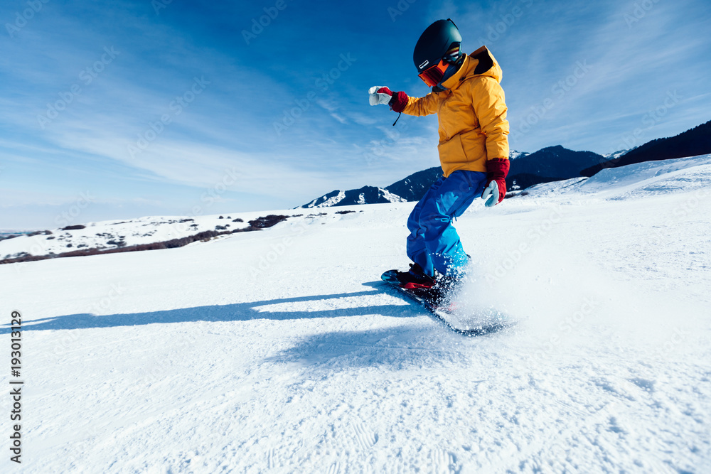 one snowboarder snowboarding in winter mountains