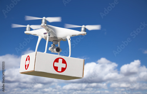 Unmanned Aircraft System (UAS) Quadcopter Drone Carrying First Aid Package In The Air.