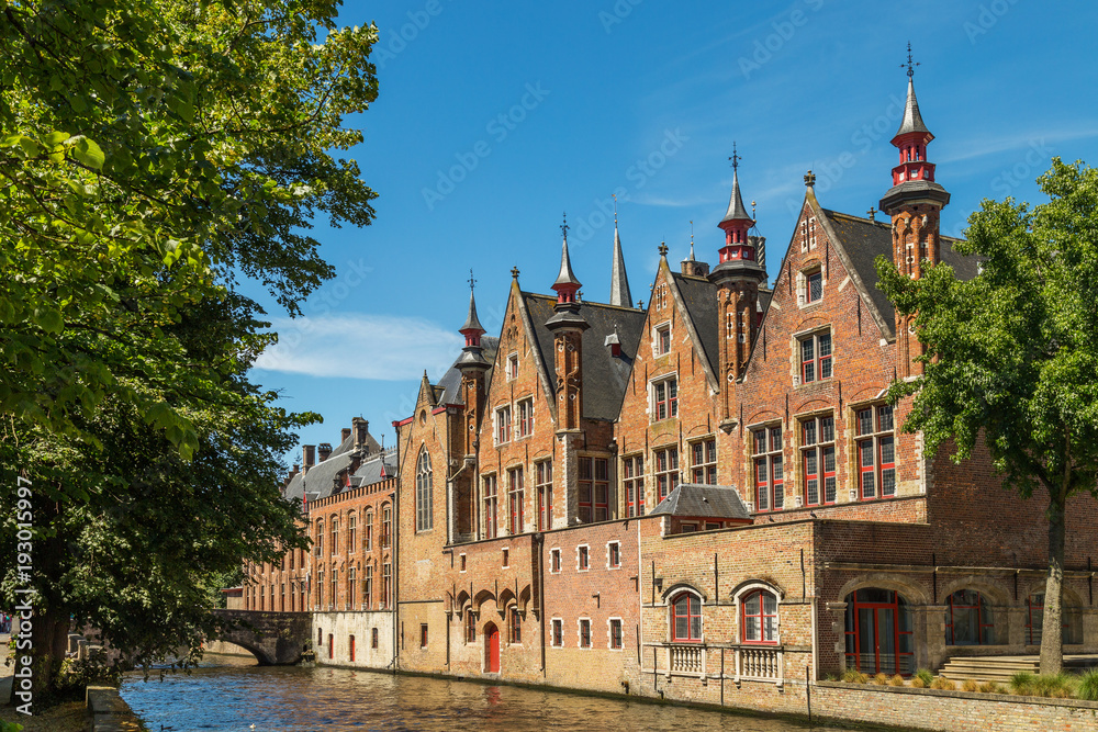 Typical medieval Flemish architecture of Bruges, Belgium. Red brick houses standing on canals