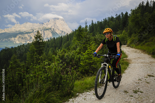 Mountain biking woman in Dolomites, Italy