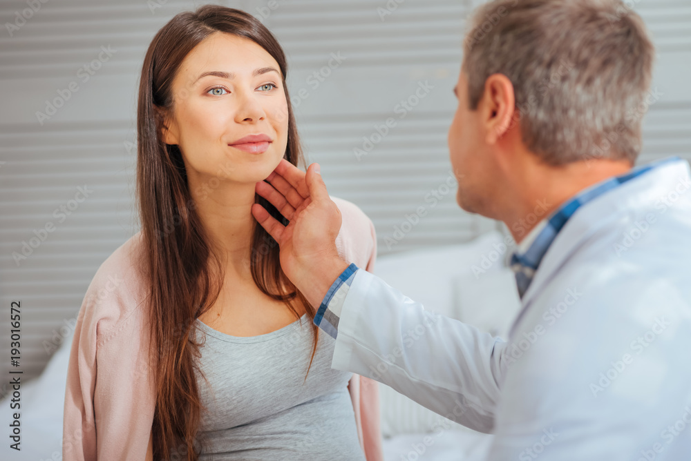 Perfect health. Positive minded young woman smiling while visiting her pediatrician and checking up her health at clinic. Perfect health. Positive minded young woman smiling while visiting her pediatrician and checking up her health at clinic.