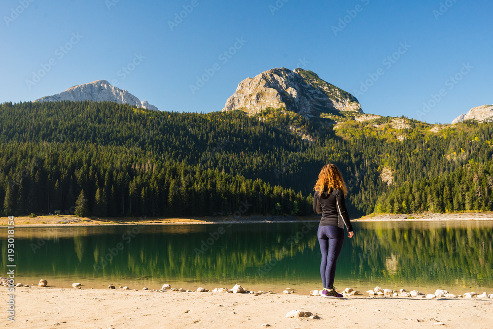 Young woman at the Black lake in Durmitor national park, Montenegro