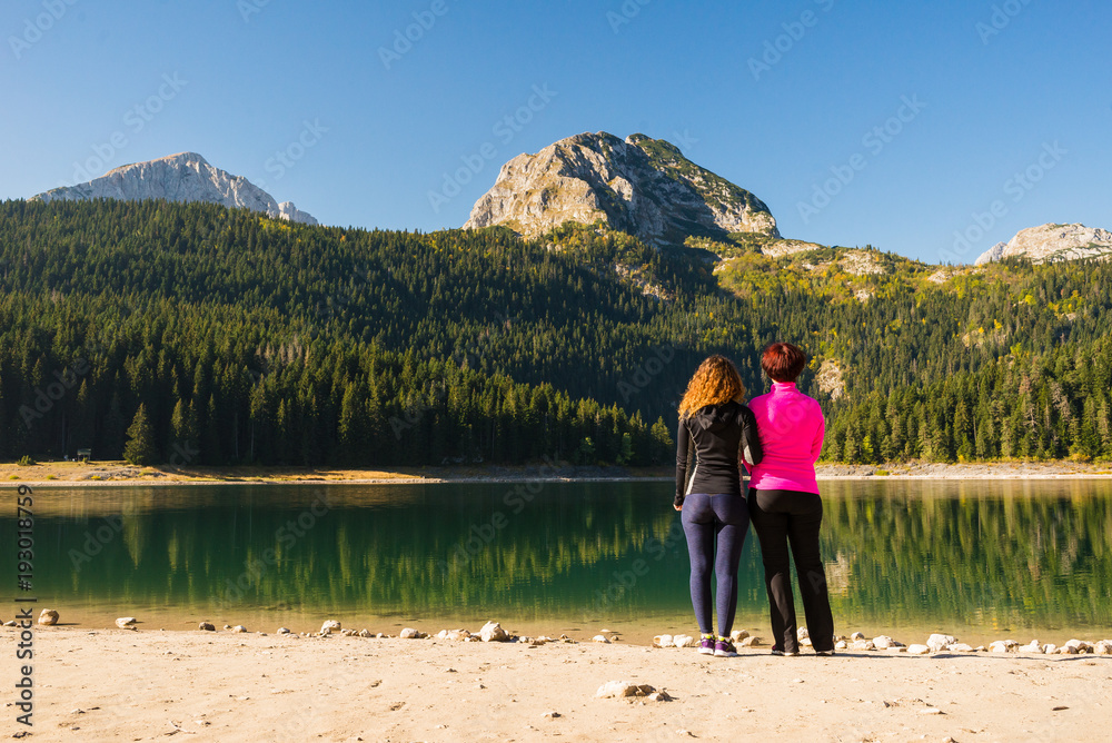 Two women at the Black lake in Durmitor national park, Montenegro
