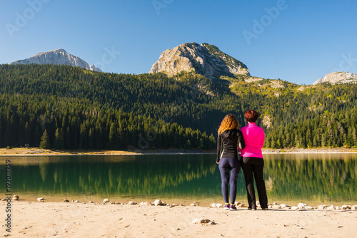 Two women at the Black lake in Durmitor national park, Montenegro © blazekg