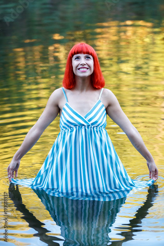 Fototapeta Naklejka Na Ścianę i Meble -  Happy woman bathing in a beautiful river