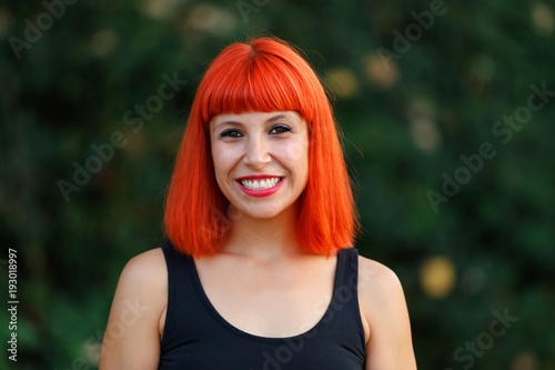 Excited woman with red hair enjoing life