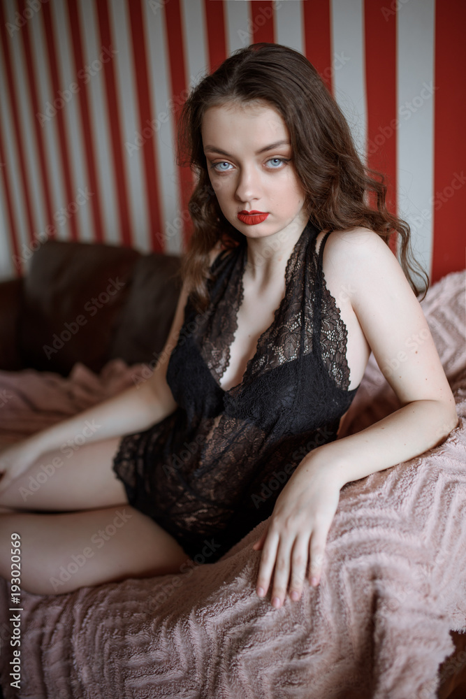 Sexy young passionate brunette woman in body bra posing on carpet Sexy young passionate brunette woman in body bra posing on carpet