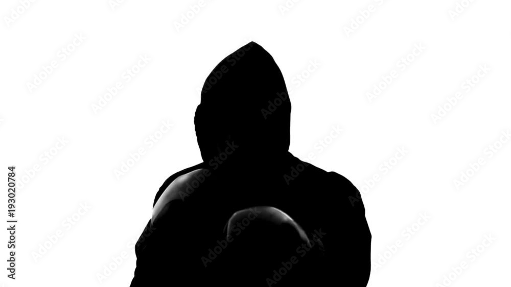 Dark male silhouette in hood attacking opponent, shadow-boxing, self-defense Dark male silhouette in hood attacking opponent, shadow-boxing, self-defense