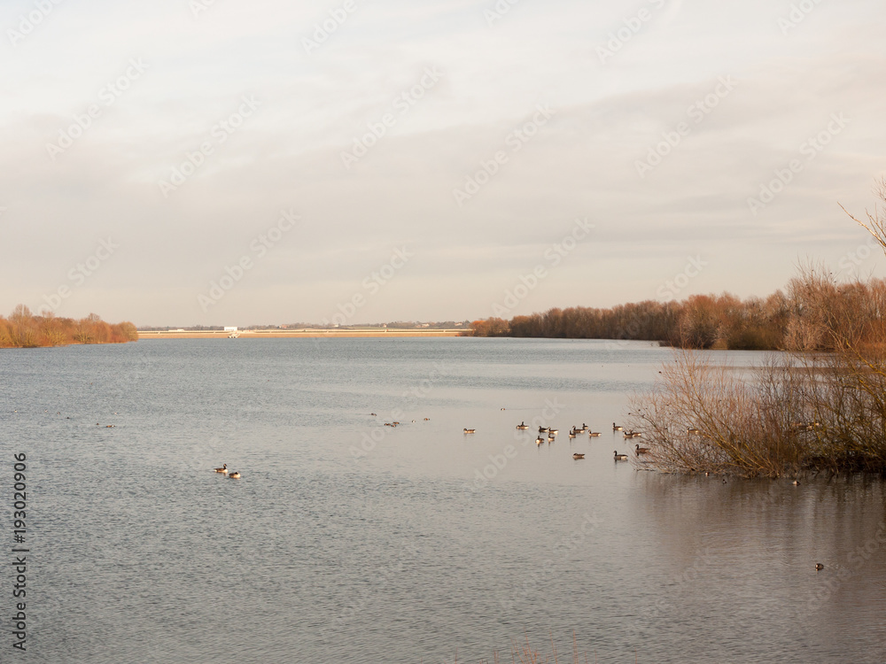 coast flat water surface reservoir scene dam in distance