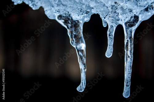 blue ice icicles on a black background