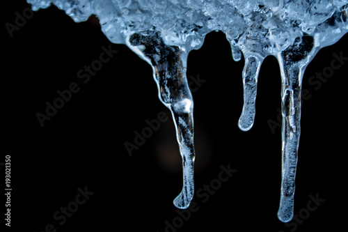 blue ice icicles on a black background