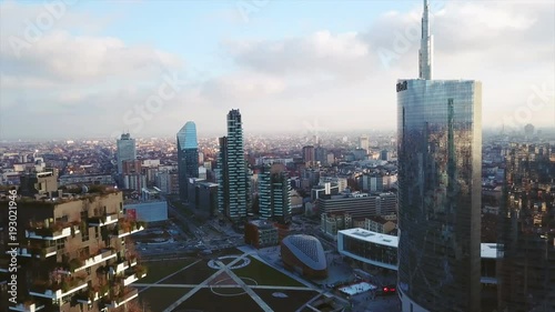 Aerial footage shooting with drone on Milan skyline and vertical forest (bosco verticale) at sunset photo