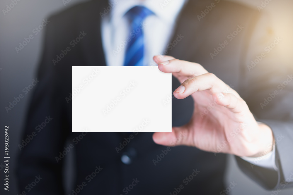 Businessman holding white business card.