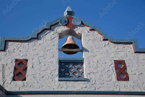 Photo of the top of a spanish mission bell towers against a blue sky in Gilroy,California photo