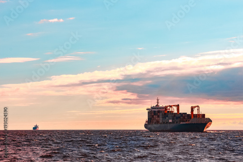 Blue container ship underway