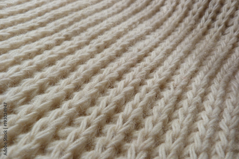 knitted scarf close-up beige knitted fabric yarn wool acrylic cotton natural thread close-knit vintage background for decoration hand-made background made by hand knitted scarf close-up beige knitted fabric yarn wool acrylic cotton natural thread close-knit vintage background for decoration hand-made background made by hand