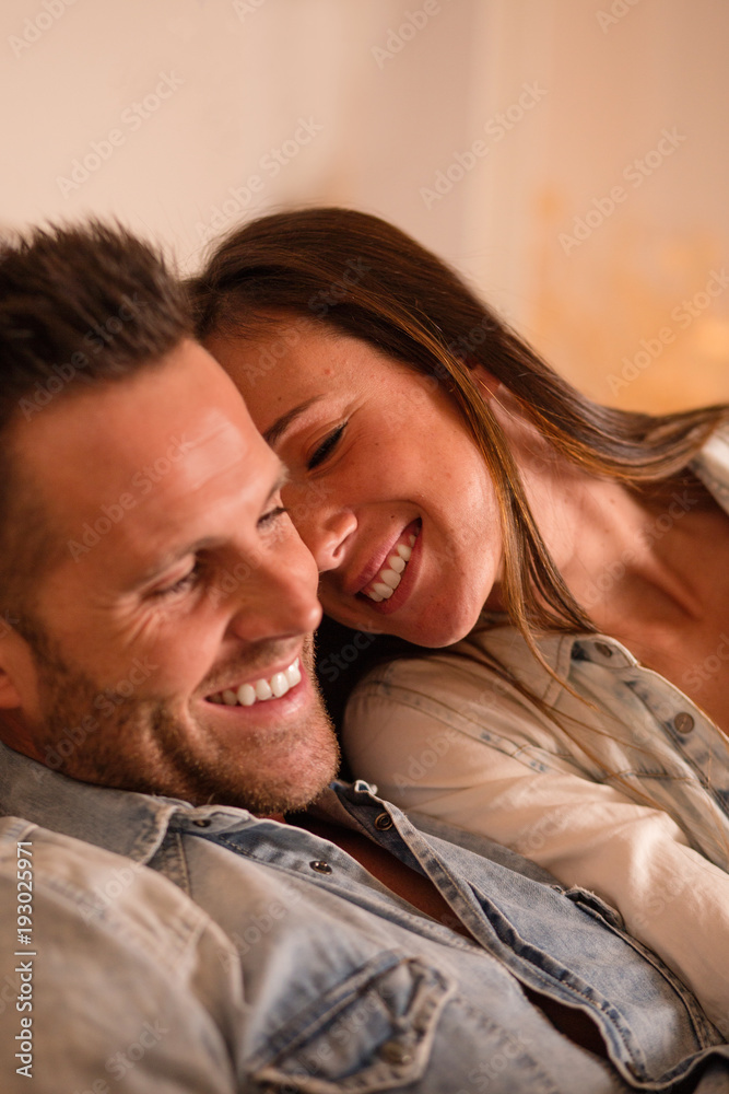 Young loving couple lying together Young loving couple lying together