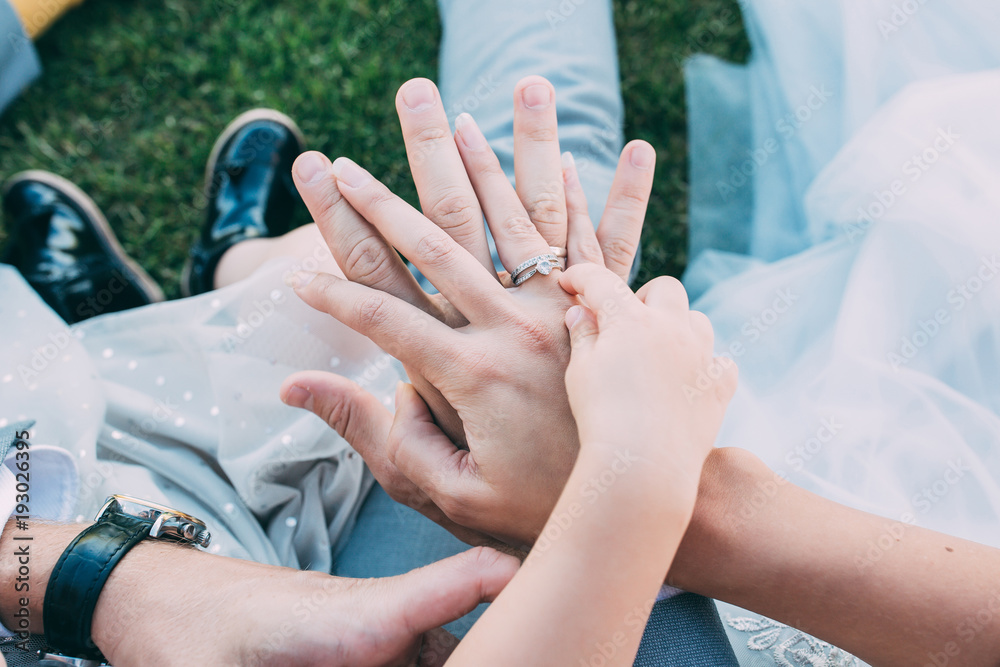 Fototapeta premium Mom's, daddy's and daughter's hands