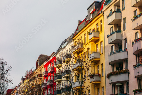 some apartment buildings with red and yellow facade