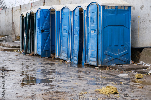 blue portable toilets on the construction site