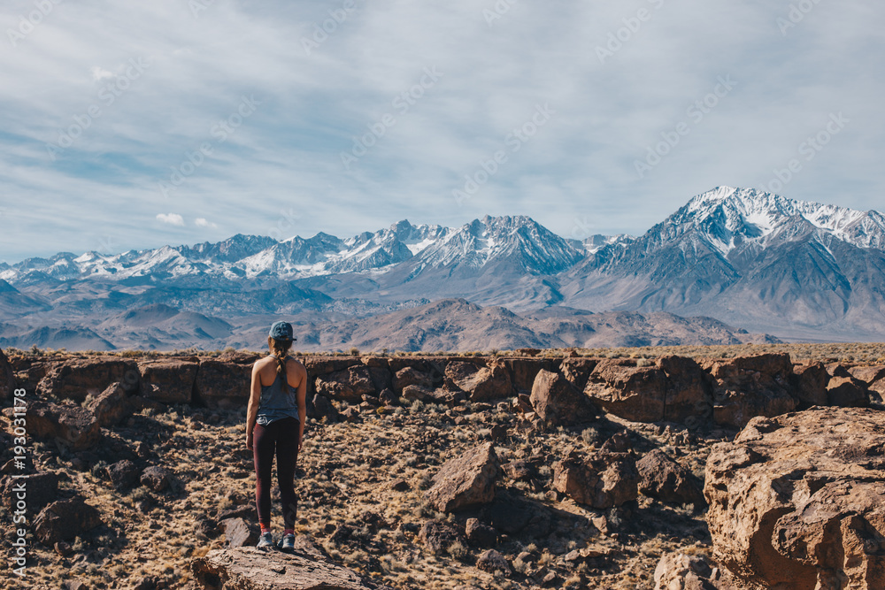 Young Woman Hiking in the Mountains with Rocks Young Woman Hiking in the Mountains with Rocks