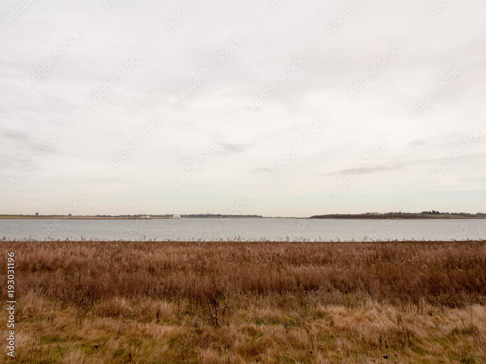 open sea coast plain with grass in front horizon overcast clear calm open sea coast plain with grass in front horizon overcast clear calm